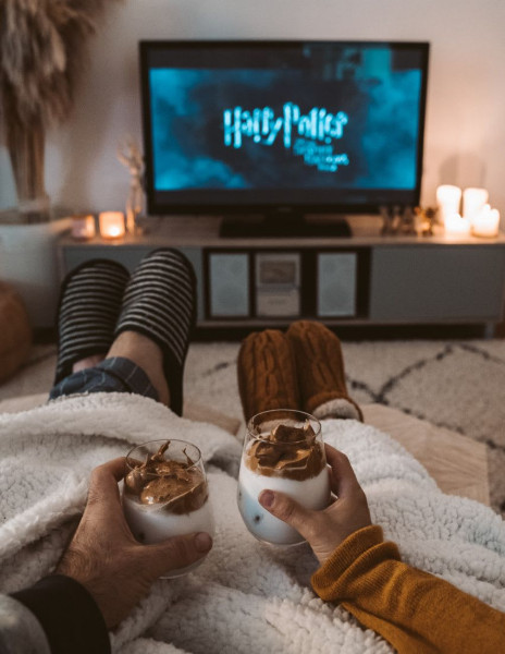A couple watching Harry Potter and drinking chocolate milk