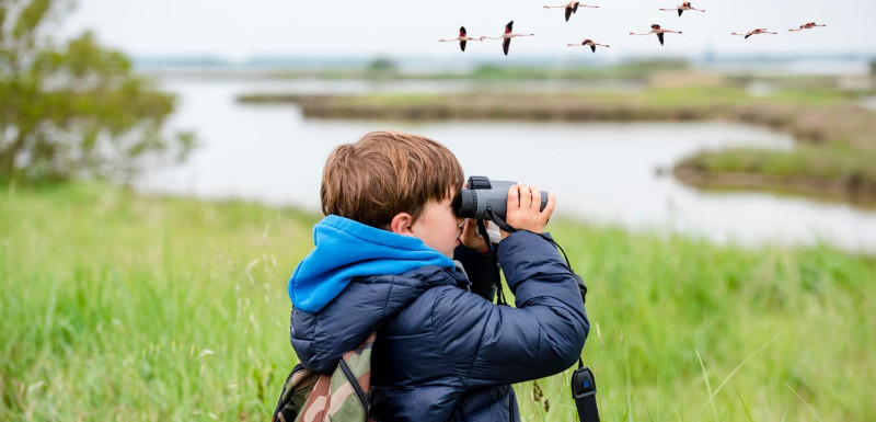 A boy with binoculars